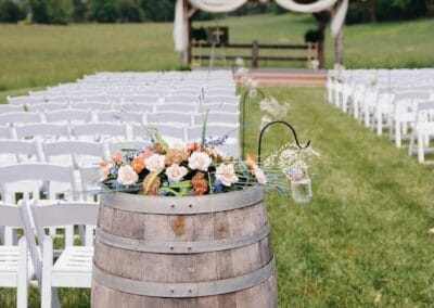 A barrel with flowers at the head of the aisle for a wedding at The Barn at Stony Creek Farm in Dungannon, Virginia.