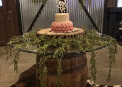 A wedding cake on a table at The Venue @ Circle V Stables.