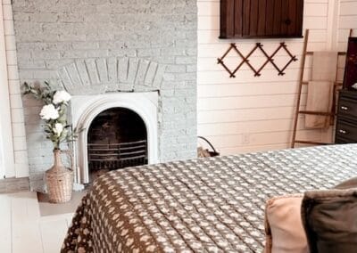 A fireplace in a bedroom at Sally Pete's Farmhouse.