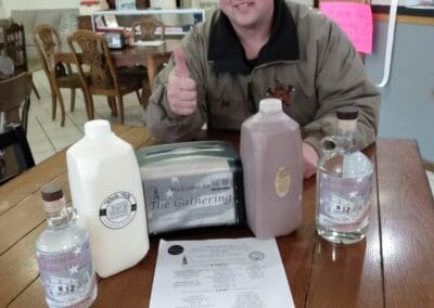 A man with a half gallon of Creamline Whole Milk from Nash Creamery.