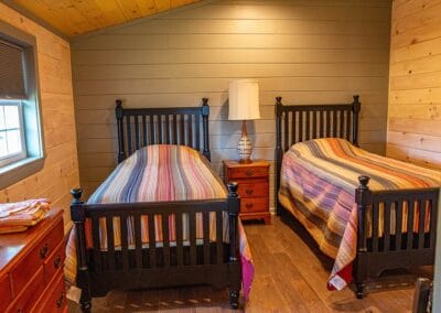 A bedroom with two beds inside Happy Trails Cottage.
