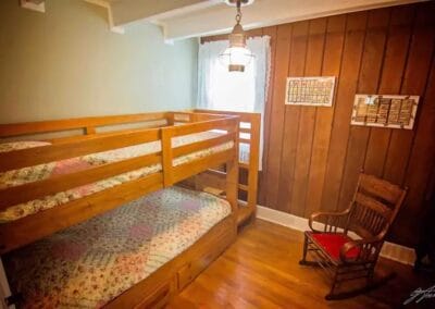 A bedroom with bunk beds inside the Fulkerson-Hilton House.