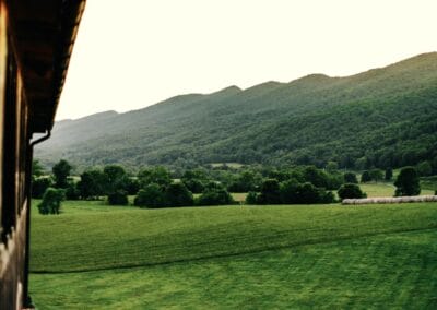Lush green mountains flank The Lodge at Crooked River.
